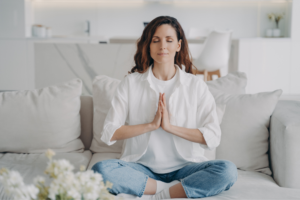 Woman meditating to reduce stress.