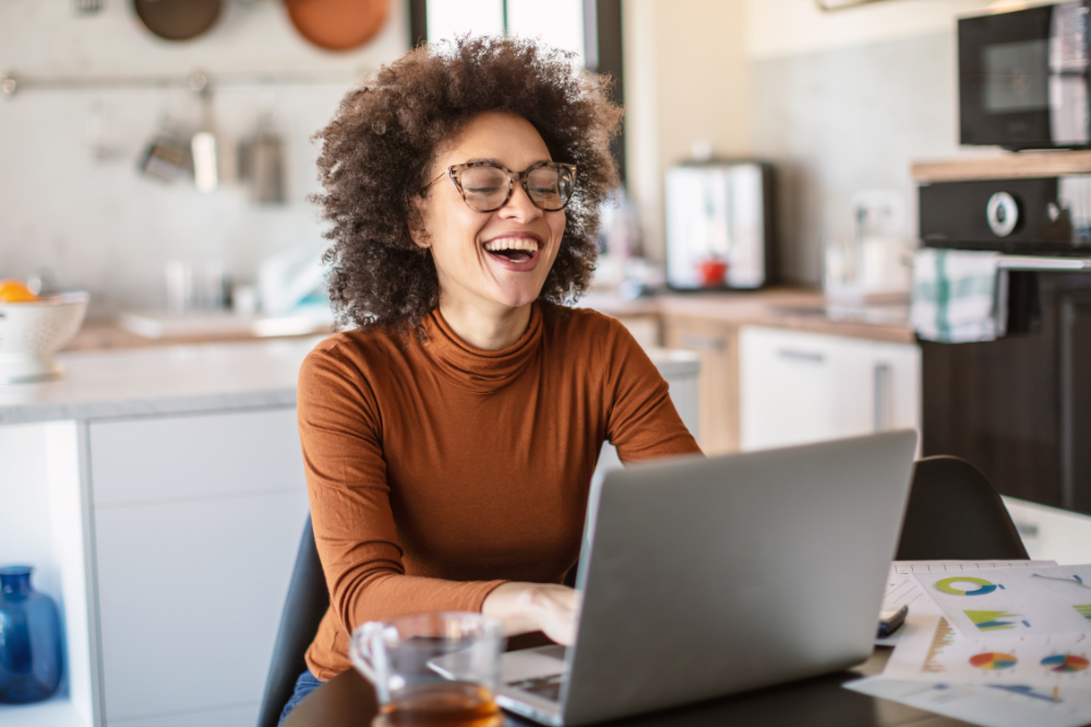 Woman sitting at desk, working from home.