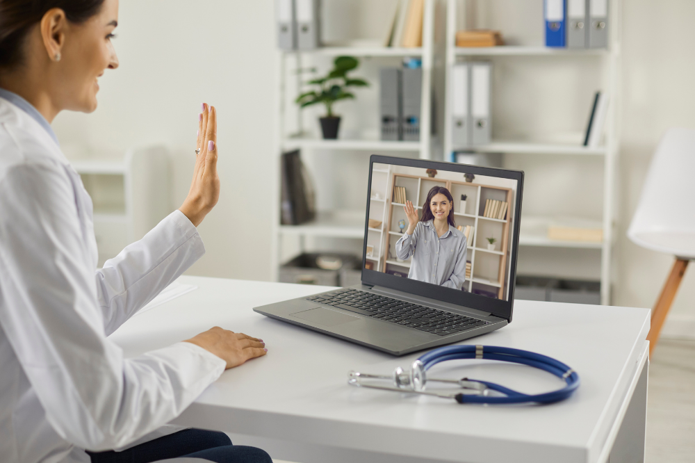 Corporate employee using telehealth on laptop.