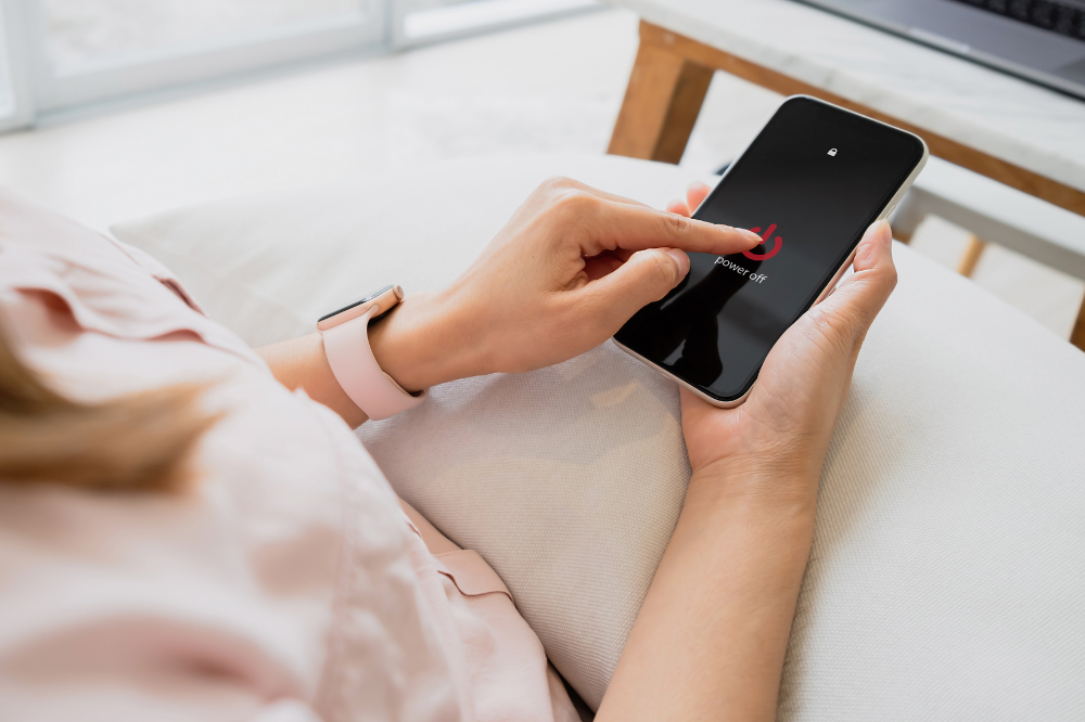 Woman switching off phone.